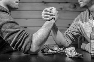 Arm wrestling over money